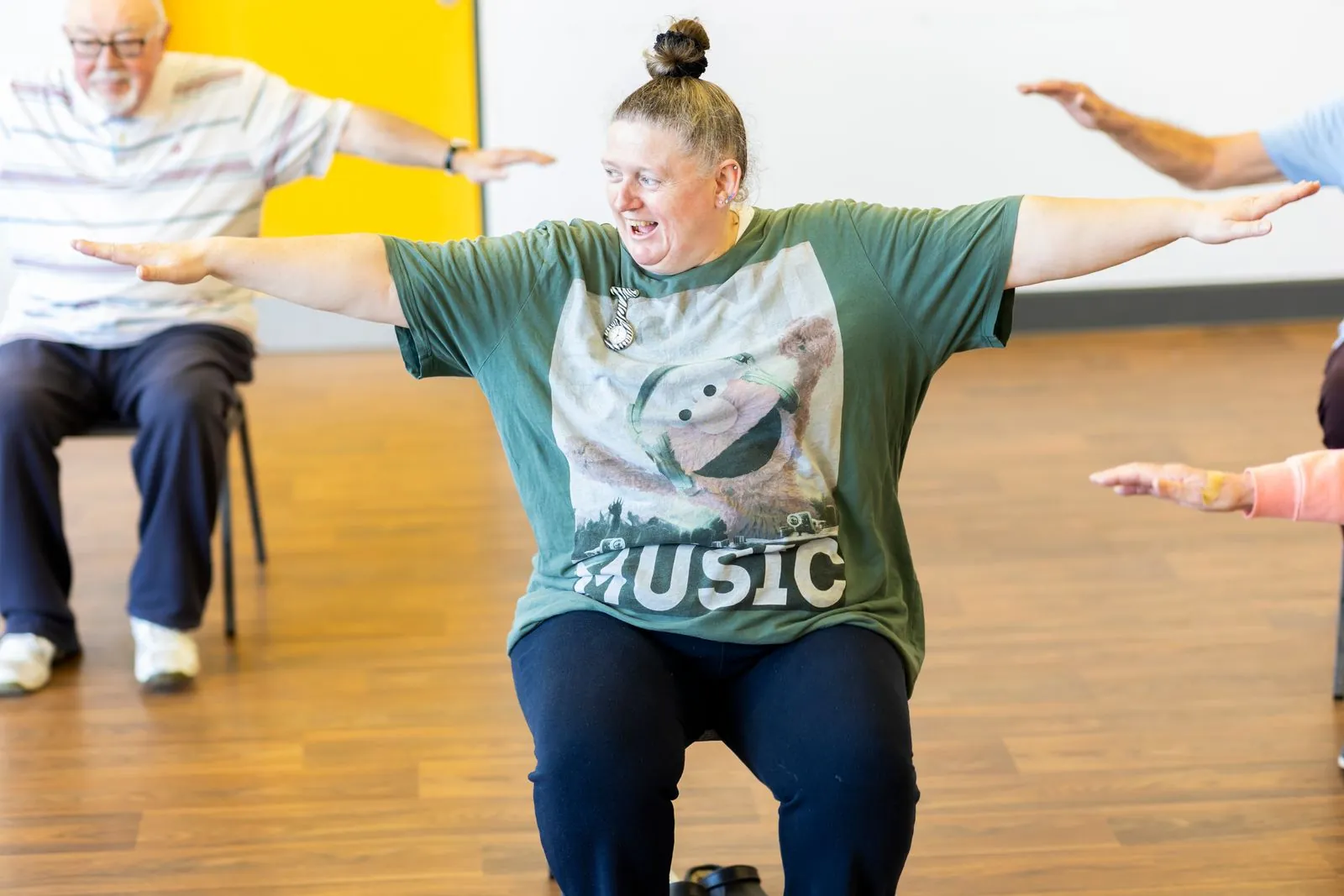 Older adults taking part in a seated exercise class