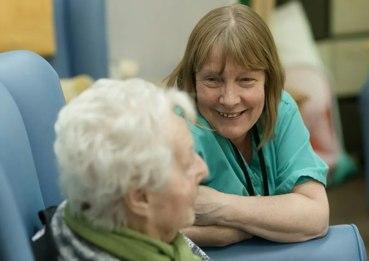 A nurse talking with a resident