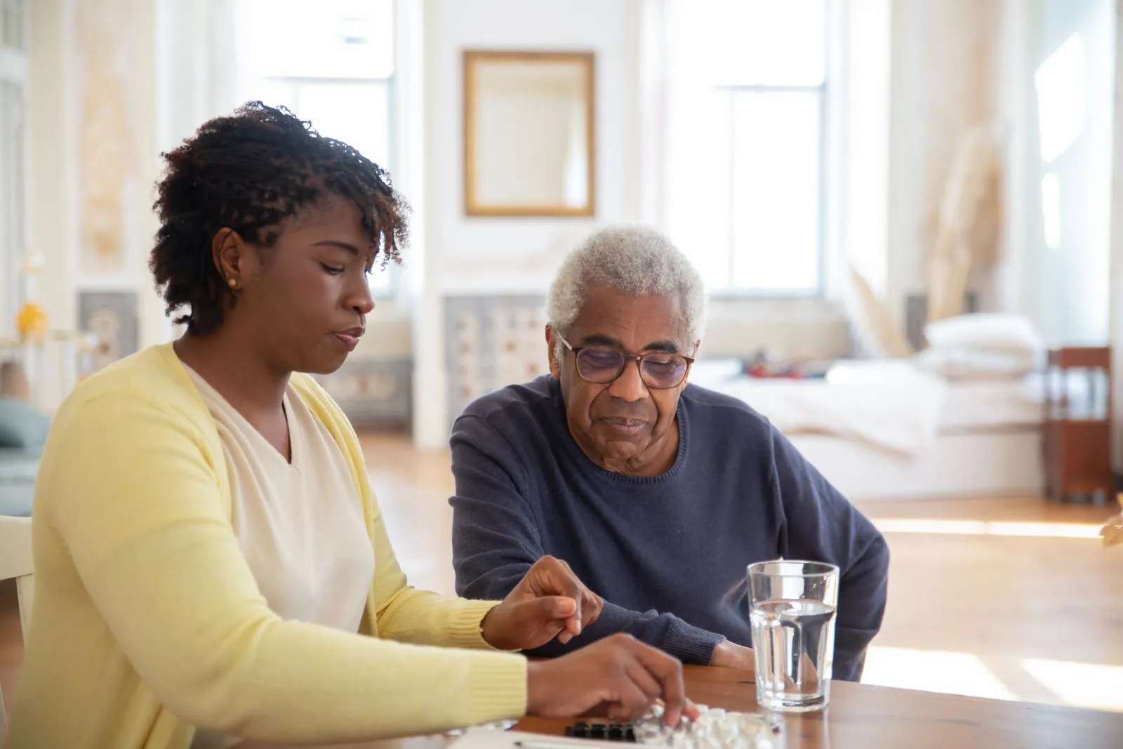 A nurse explaining medication to an older man
